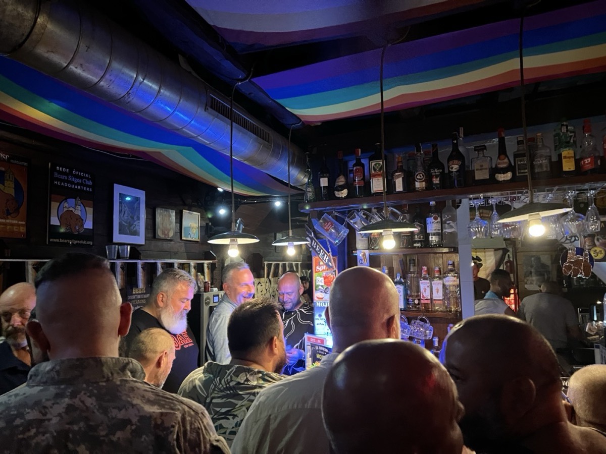 Gay bar interior with rainbow ceiling and draped lights, Sitges, Spain