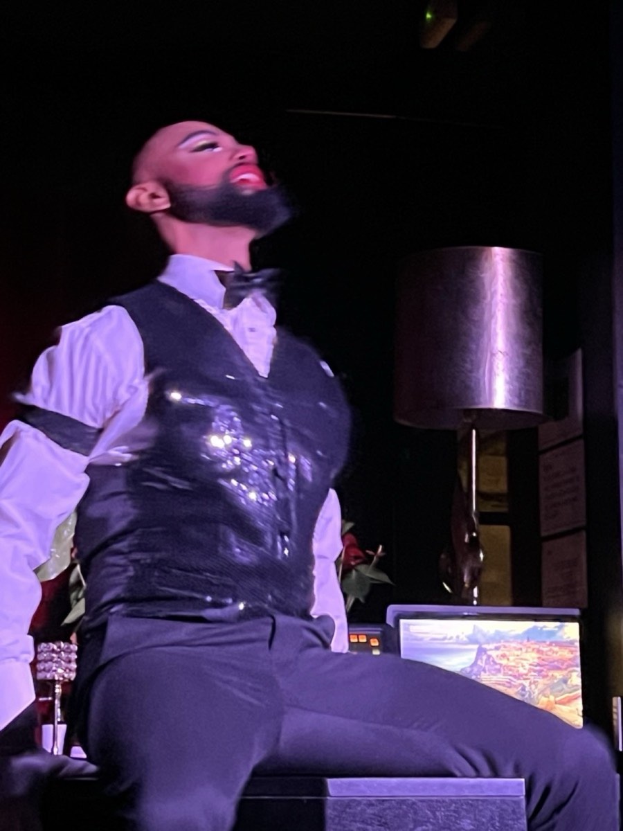 Crowd celebrating at a pride event with colorful flags